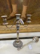 A silver plated two armed candelabra measures 41cm high along with an Epns ladle