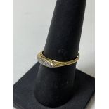 An Edwardian gold ring marks rubbed with a set of five graduated diamonds, size O/P, weighs 1.62