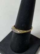 An Edwardian gold ring marks rubbed with a set of five graduated diamonds, size O/P, weighs 1.62