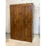 A walnut compactum, circa 1930-1940, twin panelled doors revealing interior fitted with shelves