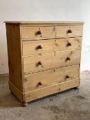 A Victorian style pine chest, fitted with two short and three long graduated drawers, raised on