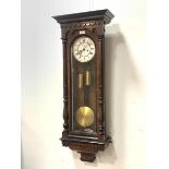 A Victorian walnut cased Vienna wall clock, the ebonised cornice over split turned pilasters