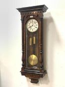 A Victorian walnut cased Vienna wall clock, the ebonised cornice over split turned pilasters