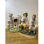 A 19thc Staffordshire figure group entitled Tam. O. Shanter. And. Sooter Johnny, measures 33cm