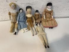 A 19thc peg doll with simple jointed body and painted face, measures 30cm long, along with a