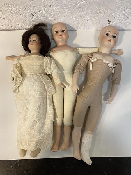 A modern bisque head doll stamped verso CP England EJ 1982 with stuffed body, bisque arms and