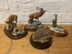 A group of four Border Fine Arts sculptures including stag, fox, otter and hedgehog, all with bases,