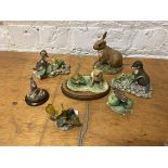 A collection of Border Fine Arts sculptures including butterflies, rabbits, duckling, otter,