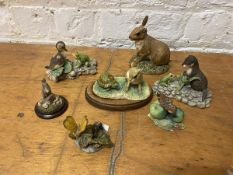 A collection of Border Fine Arts sculptures including butterflies, rabbits, duckling, otter,