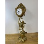 A Swiss gilt metal clock with scrolling fruiting vine and cherub design, roman numerals, measures