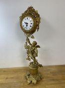 A Swiss gilt metal clock with scrolling fruiting vine and cherub design, roman numerals, measures
