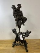 A large late 19thc Chinese rootwood carving of a Lohan man with one leg raised on a tripod bough