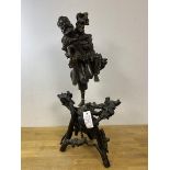 A large late 19thc Chinese rootwood carving of a Lohan man with one leg raised on a tripod bough