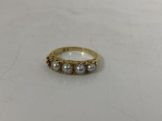 An 18ct gold ring with four graduated pearls, one lacking, with chipped diamonds, size L, weighs 3.