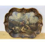 A 19thc painted tray, the scalloped edge with gilt decoration, well depicting figures by stream near