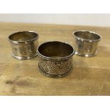 A pair of Sheffield silver napkin rings and a Victorian Scottish silver napkin ring, makers mark WM,