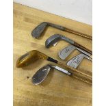 A collection of vintage hickory shafted golf clubs including those by Spalding, Walter Hagen, JJ