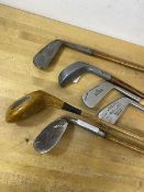 A collection of vintage hickory shafted golf clubs including those by Spalding, Walter Hagen, JJ