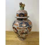 A large 19thc Japanese Imari baluster shaped vase and cover, with Lion finial, some repairs,