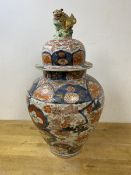A large 19thc Japanese Imari baluster shaped vase and cover, with Lion finial, some repairs,