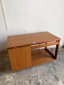 A Mid Century teak coffee table, the rectangular top swivels and opens over a cupboard and recess