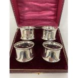 A set of four 1919 Birmingham silver napkin rings in original box, combined weight 90 grammes
