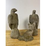 A pair of garden composition garden figures of eagles, one lacking beak, measure 44cm high, along