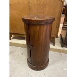 A Victorian mahogany cylindrical bedside cabinet, the curved door enclosing a single shelf, on
