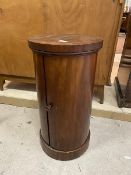 A Victorian mahogany cylindrical bedside cabinet, the curved door enclosing a single shelf, on