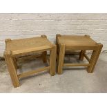 A pair of oak side tables, the rectangular tops within raised supports, each lacking apron to one