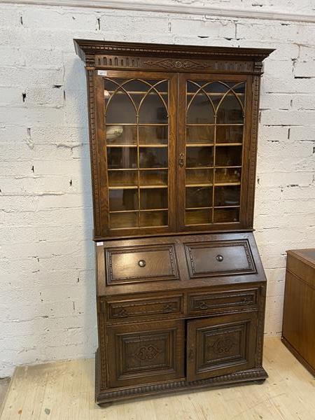 An early 20thc oak 2-part bureau bookcase, dental cornice above twin glazed doors enclosing three