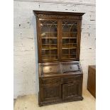 An early 20thc oak 2-part bureau bookcase, dental cornice above twin glazed doors enclosing three