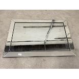A contemporary wall mirror, the rectangular bevelled glass within a mirrored bevelled frame,