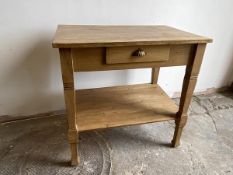 A pine side table with rectangular top with single frieze drawer over lower tier supported by