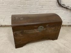 A Chinese dome topped padauk wood chest with drop handles to sides, interior single sliding shelf on