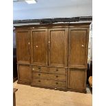 A late 19th early 20thc Waring & Gillow style mahogany breakfront wardrobe with dental cornice