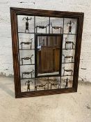 A modern African wall mirror, the rectangular glass within segmented metal border, each with wood
