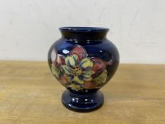 A Moorcroft bud vase of squat baluster form with label to base, Potters to the Late Queen Mary,