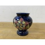 A Moorcroft bud vase of squat baluster form with label to base, Potters to the Late Queen Mary,