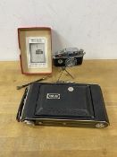 Camera Interest :- a Photolite novelty table lighter in the form of a camera on tripod, measures 9cm