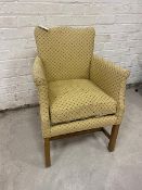 A Georgian inspired upholstered armchair, the undulating top over a sprung seat with drop in cushion