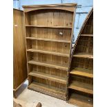 A pine upright open bookcase with five shelves on plinth base, measures 183cm x 96cm x 21cm