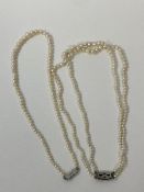 Two pearl graduated necklaces, both with silver clasps. One is a two string necklace which