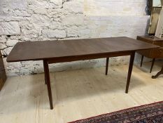 A Mid Century extending dining table with two extra leaves on turned tapering supports, measures