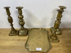 A collection of brassware including two pairs of candlesticks, measuring 25cm high and a tray with
