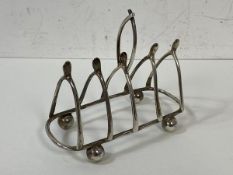A 1903 Birmingham silver novelty toast rack, makers mark N&W, having wish bone partitions,