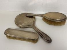 A 1920's Birmingham silver hand mirror, measures 28cm long, along with two brushes (a lot)