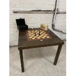 A square dining table, the central section reversible, with chequer board verso, along with a