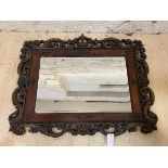 A first half of the 20thc wall mirror, the bevelled rectangular glass within a studded leather