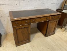 A Victorian mahogany twin pedestal kneehole desk, the top with insert skiver writing surface over